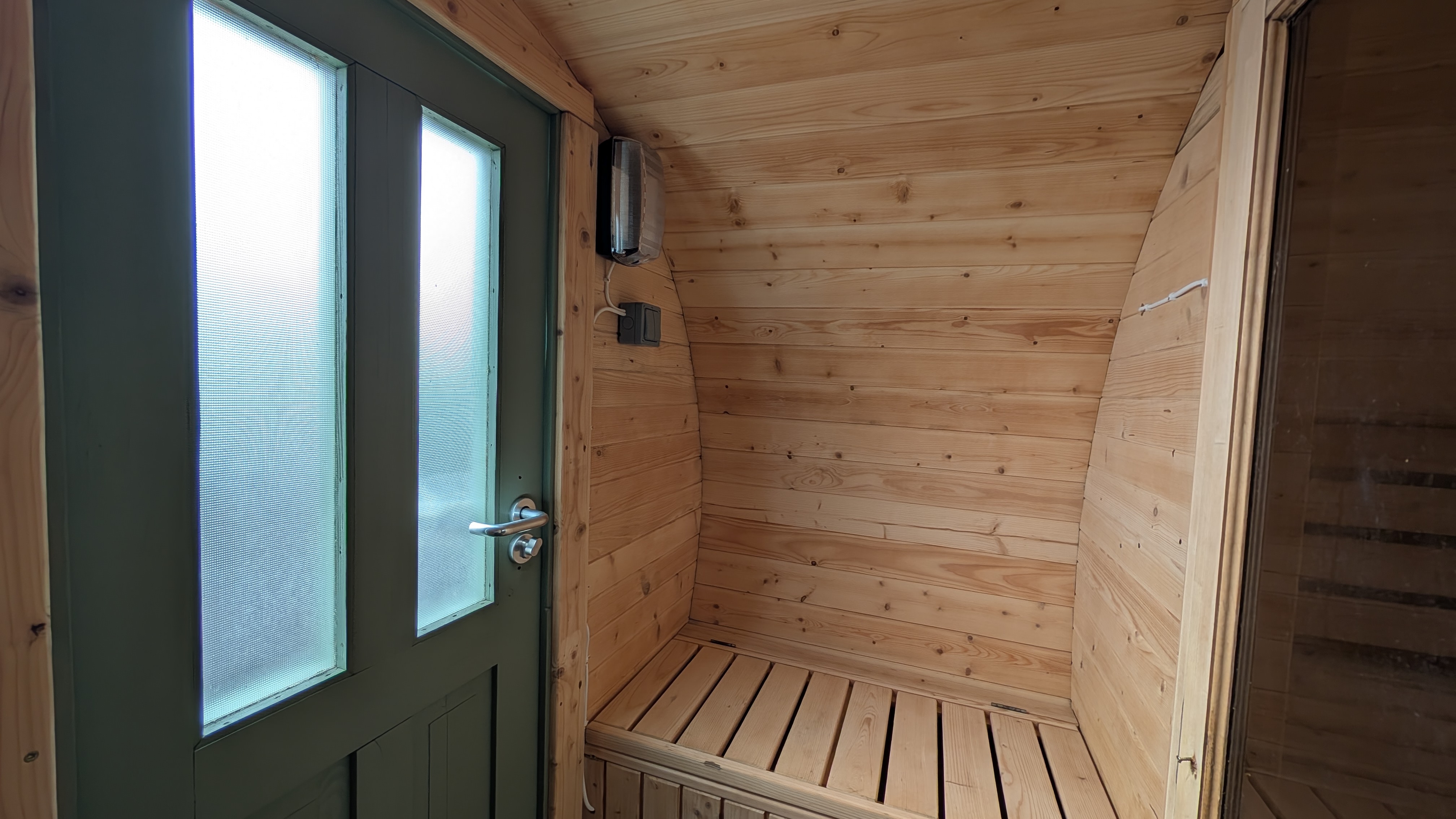 Sauna interior with door and lighting