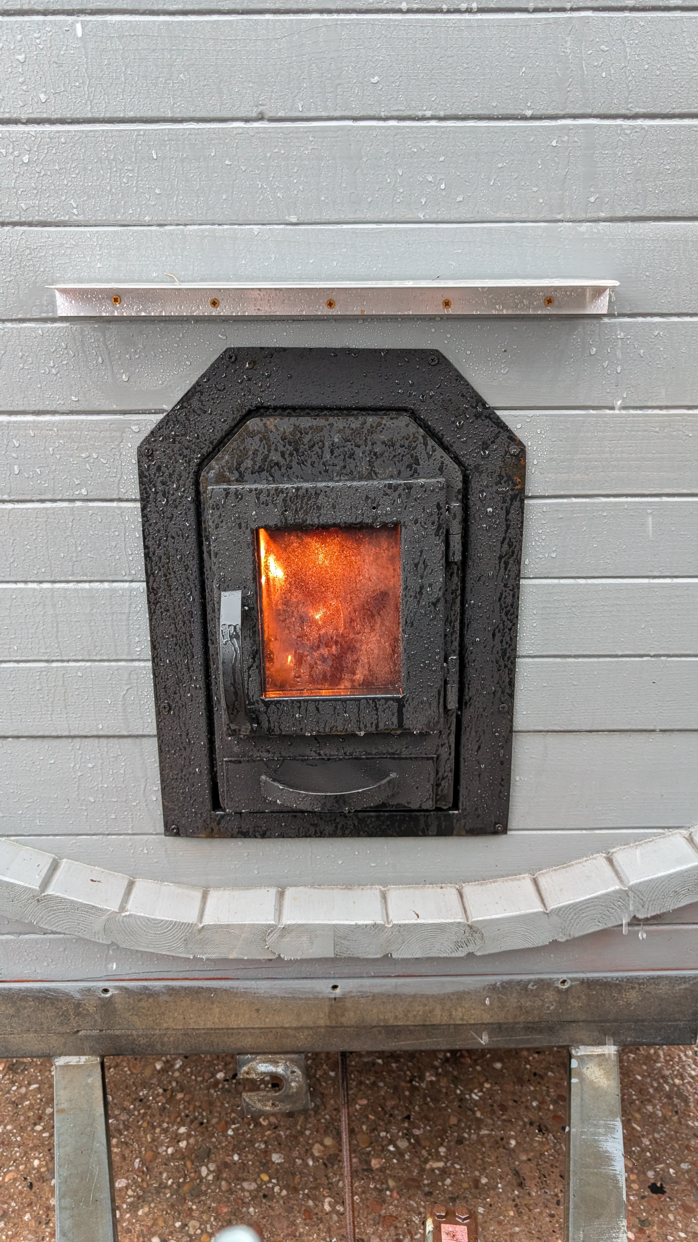 Sauna stove door with glowing fire